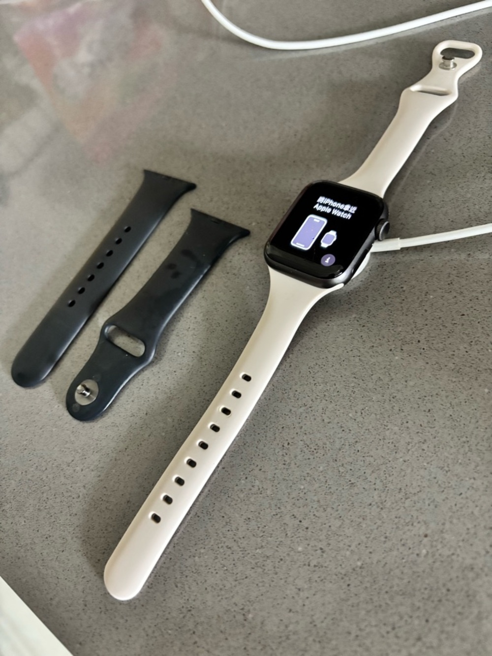 Apple Watch SE with Navy Band and Beige Spare Bands